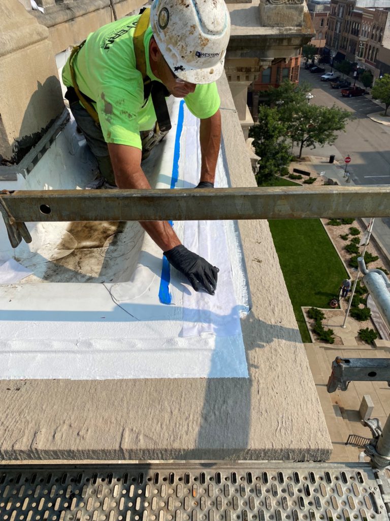 Reinforced Liquid flashings being installed over the termination bar to achieve a 30 year warranted system on the gutter edge.